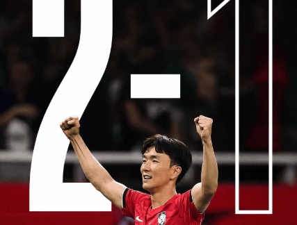 Soccer player in a red jersey celebrates with fists raised, overlaid by the scoreline 2–1.